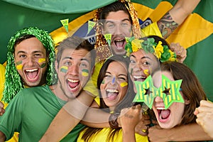 Brazilian sport soccer fans celebrating victory together.