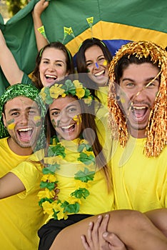 Brazilian sport soccer fans celebrating victory together.