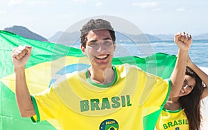 Brazilian sports fans with jersey and flag