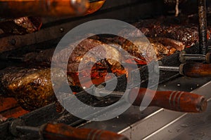 Brazilian style beef ribs Barbecue grill on skewers at a churrascaria steakhouse photo
