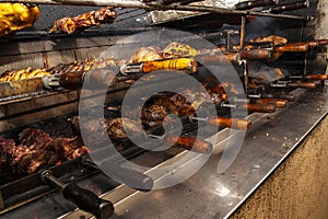 Brazilian style beef ribs Barbecue grill on skewers at a churrascaria steakhouse photo