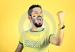 Brazilian supporter of National football team is celebrating, ch