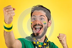 Brazilian supporter of National football team is celebrating, ch