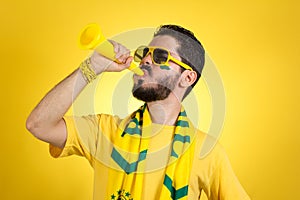 Brazilian supporter of National football team is celebrating, ch