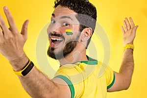 Brazilian supporter of National football team is celebrating, ch