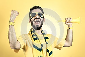 Brazilian supporter of National football team is celebrating, ch