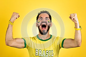 Brazilian supporter of National football team is celebrating, ch