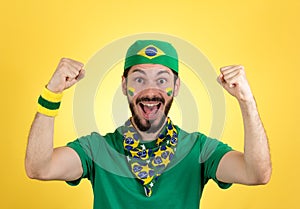 Brazilian supporter of National football team is celebrating, ch