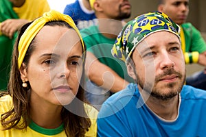 Group of fans watching a match and cheering brazilian team. photo