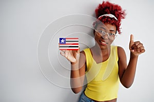 Brazilian woman with afro hair hold Maranhao flag isolated on white background, show thumb up. States of Brazil concept photo