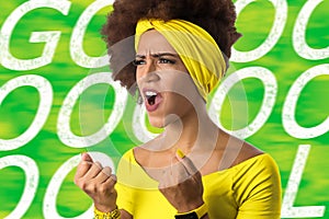 Brazilian woman fan celebrating on football match on white background. Brazil colors. photo