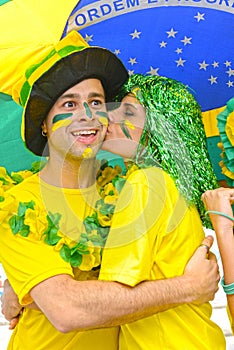 Brazilian woman soccer fans commemorating victory kissing. photo