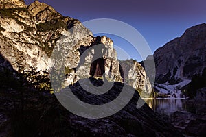 Brazilian woman watching at sunset the clear waters of Lake Braies