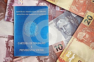 Brazilian work card and social security blue book and reais money bills