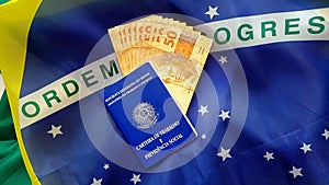Brazilian work and social security document (Carteira de Trabalho e Previdencia Social) with brazilian money and