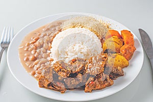 Brazillian Deli Food plate with rice, beans, vegetables and beef