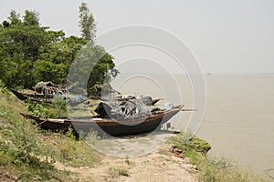 breached river boats on the bank photo