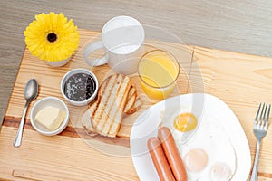 Breackfast with coffee, toasts, scrambled eggs, sausages and flower