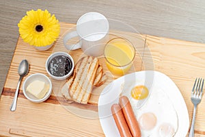 Breackfast with coffee, toasts, scrambled eggs, sausages and flower photo