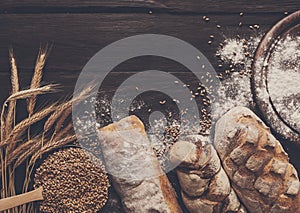 Bread bakery background. Brown and white wheat grain loaves composition