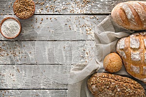 Bread bakery background. Brown and white wheat grain loaves composition on rustic wood