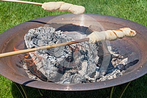 Bread baking over open fire - danish `SnobrÃ¸d`