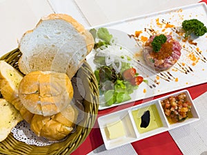 Bread basket by tuna tartar plate