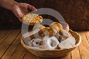 Bread basket, typical of the peoples of Mexico. With one hand taking a polvoron. 2 photo