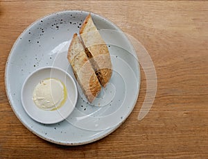 Bread and butter homemade in ceramic plate on a wooden table