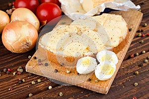 Bread with butter and slices of romadur cheese and eggs