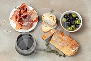 Bread ciabatta, jamon ham serrano paleta iberica, olives. Italian food ingredients, Restaurant menu, dieting, cookbook recipe top