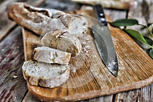 Bread. Ciabatta with pieces on a wooden table. Country style. Still life.