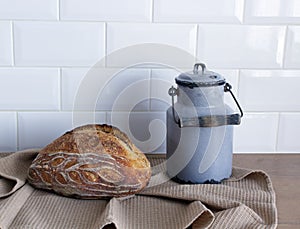 Bread close-up. Freshly baked sourdough bread with a golden crust on a table in the kitchen.