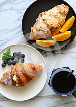 Bread, coffee, fruit on the table, rich breakfast