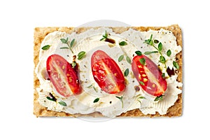 Bread crisps with cream cheese, tomato slices and herbs on white