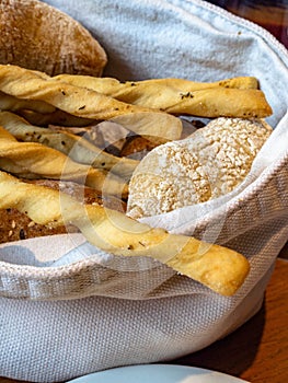 Bread and crispy breadsticks grissini in basket