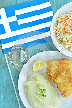 Bread crumbed cod fish and garlic dip, known as skordalia, traditional Greek dish and Greek flag