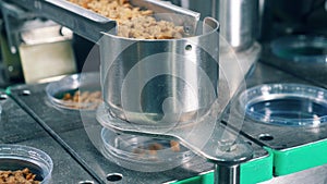 Bread crumbs are getting prepacked by an industrial machine at a food factory.