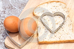 Bread cut in heart shape with eggs