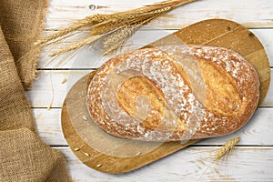 Bread on cutting board with a grain cereals