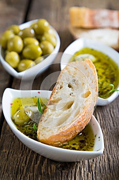 The bread dipped in olive oil with herbs and spices