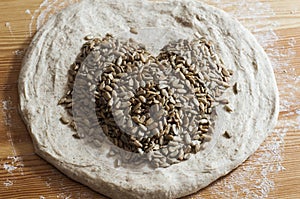 Bread dough with seeds forming a heart