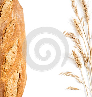 Bread, ears of wheat and oat in the form frame. Top view.