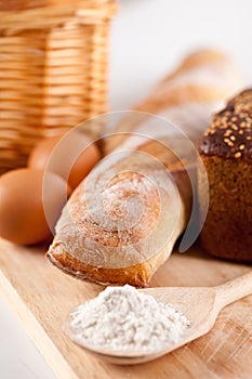 Bread, flour, eggs and kitchen utensil