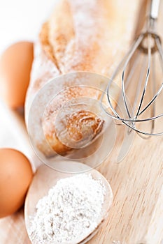 Bread, flour, eggs and kitchen utensil