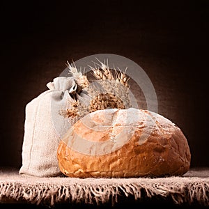 Bread, flour sack and ears bunch still life