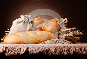 Bread, flour sack and ears bunch still life