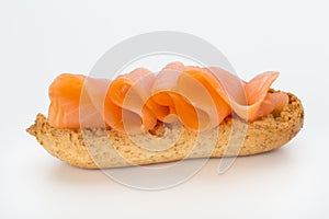 Bread with fresh salmon fillet isolated on white background, top view