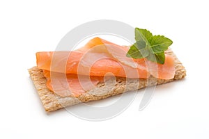 Bread with fresh salmon fillet isolated on white background, top view