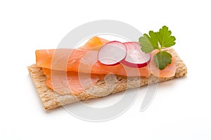 Bread with fresh salmon fillet isolated on white background, top view